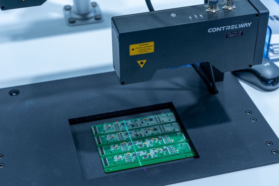 Circuit board being processed by a precision machine