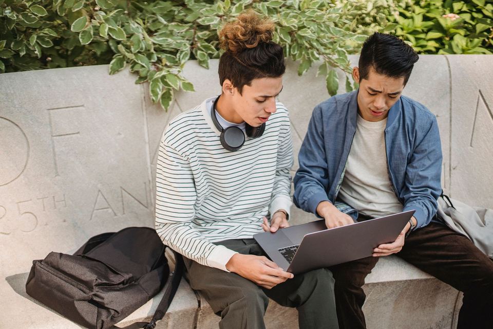 Two learners working together on a laptop
