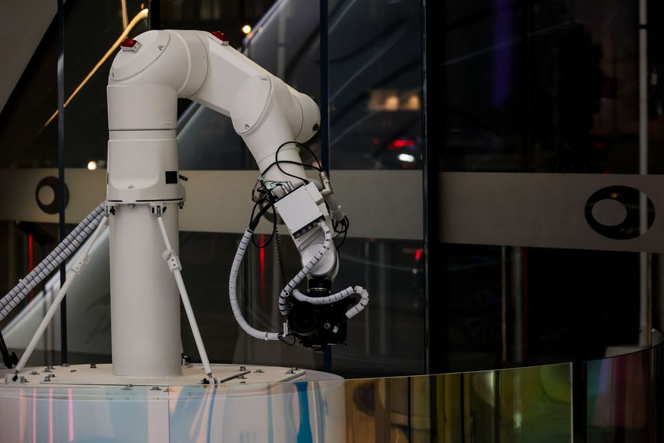 White robotic arm against a dark background
